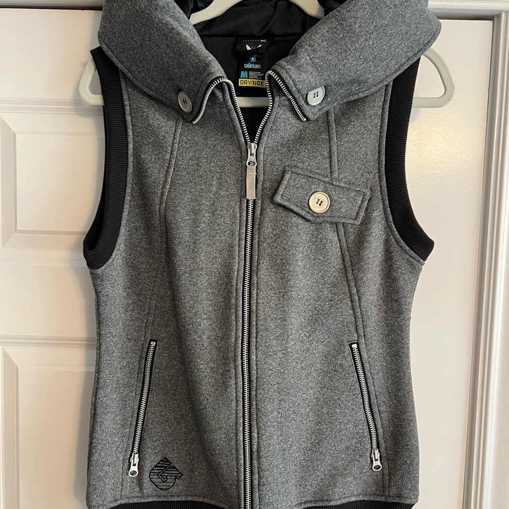 Keep warm with this grey & black utility vest. Great for layering or on its own